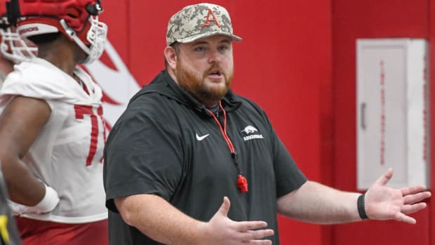 Arkansas offensive line coach Eric Mateos works with his players at spring practice.
